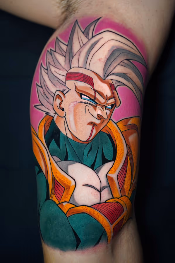 Colorful tattoo of Baby Vegeta from Dragon Ball GT with spiky silver hair, a green and orange armor, posing with crossed arms against a pink background.