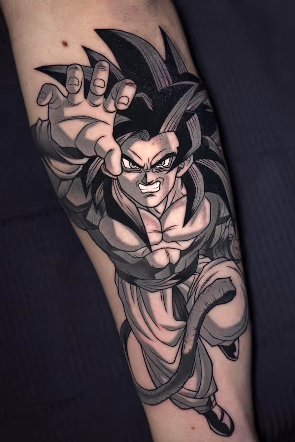 Black and gray tattoo of an aggressive anime-style warrior Son Goku  with spiky hair, muscular build, and a tail, reaching forward with one hand.