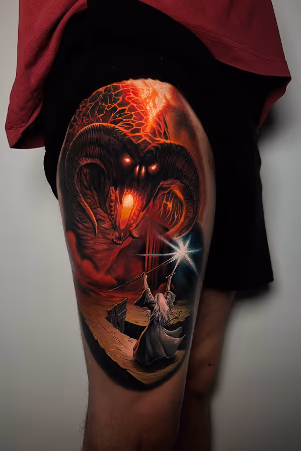Tattoo of a Gandalf with a staff casting a bright spell against a fiery, horned demon Balrog with glowing eyes and mouth.
