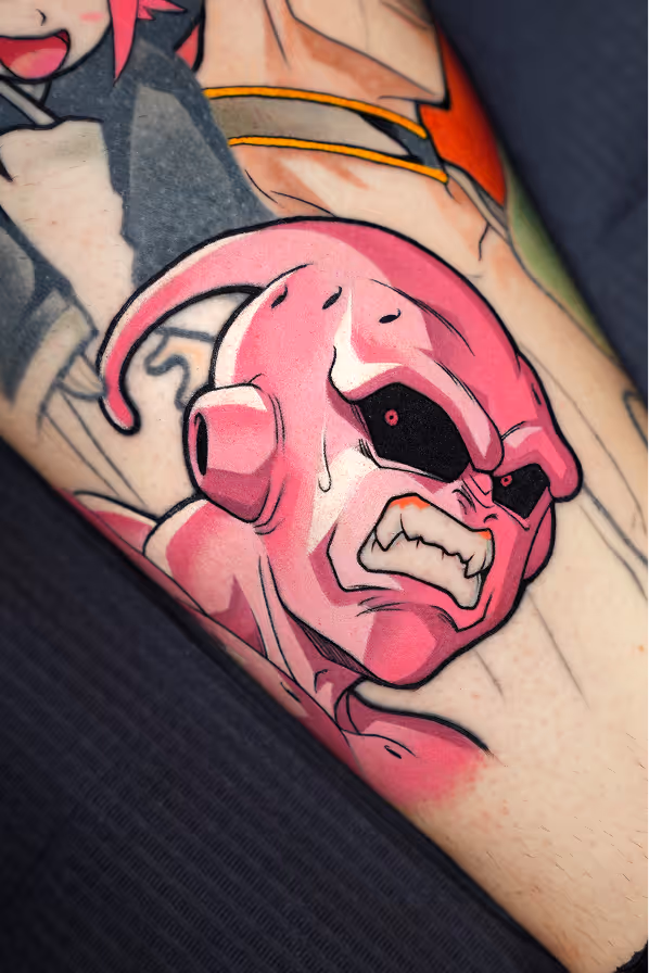 Tattoo of Majin Buu from Dragon Ball Z with an angry expression and clenched teeth.