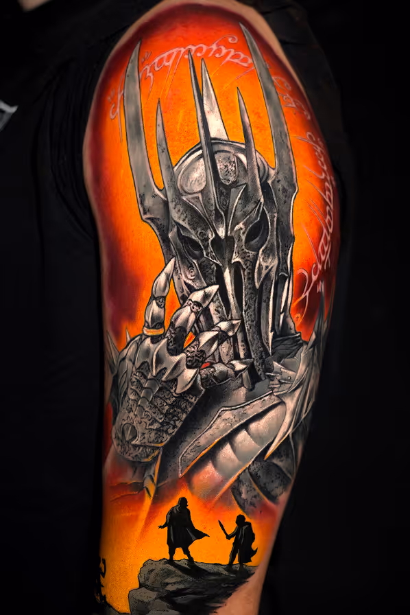Tattoo of Sauron from Lord of the Rings with fiery orange background and two small silhouetted figures with swords standing on a rock at the bottom.